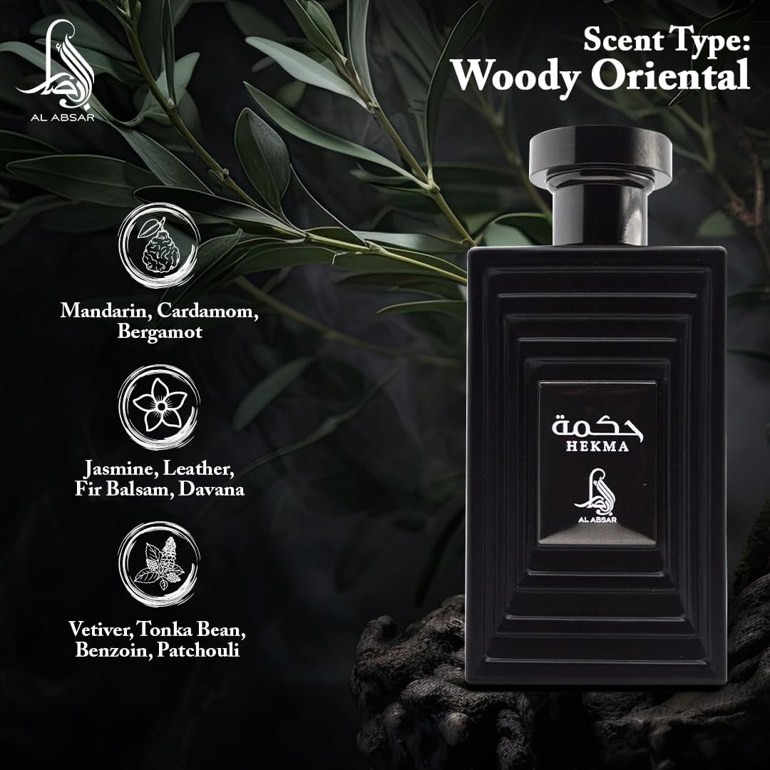 Perfume bottle with 'Hekma' branding and scent type 'Woody Oriental' on a dark background with green leaves.