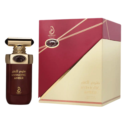 Perfume bottle with red and gold packaging on a white background. Hypnotic Amber by Arabiyat Prestige Unisex Perfume