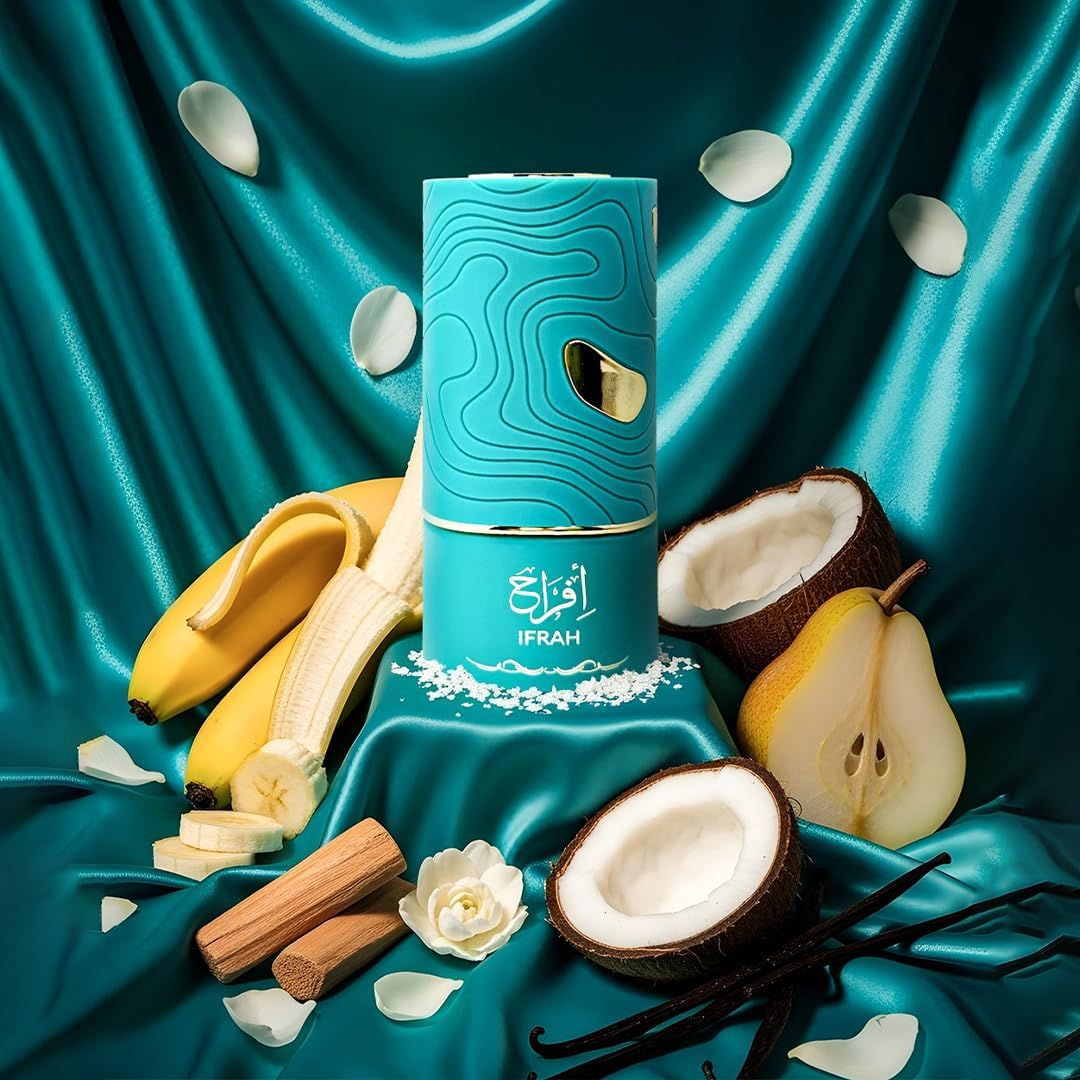 Blue perfume bottle with floral and fruit elements on a teal fabric background