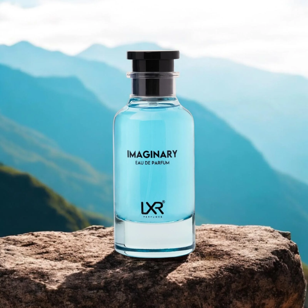 Blue perfume bottle labeled 'Imaginary' by LXR on a rock with mountain background
