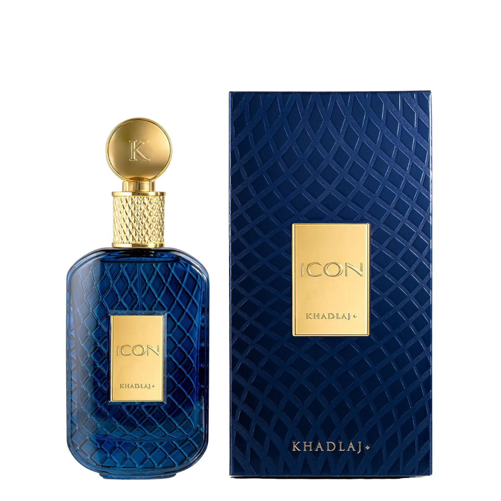 A bottle of Khadlaj Icon fragrance in a textured deep blue glass bottle with a gold cap, shown next to its matching dark blue textured box with a gold label.