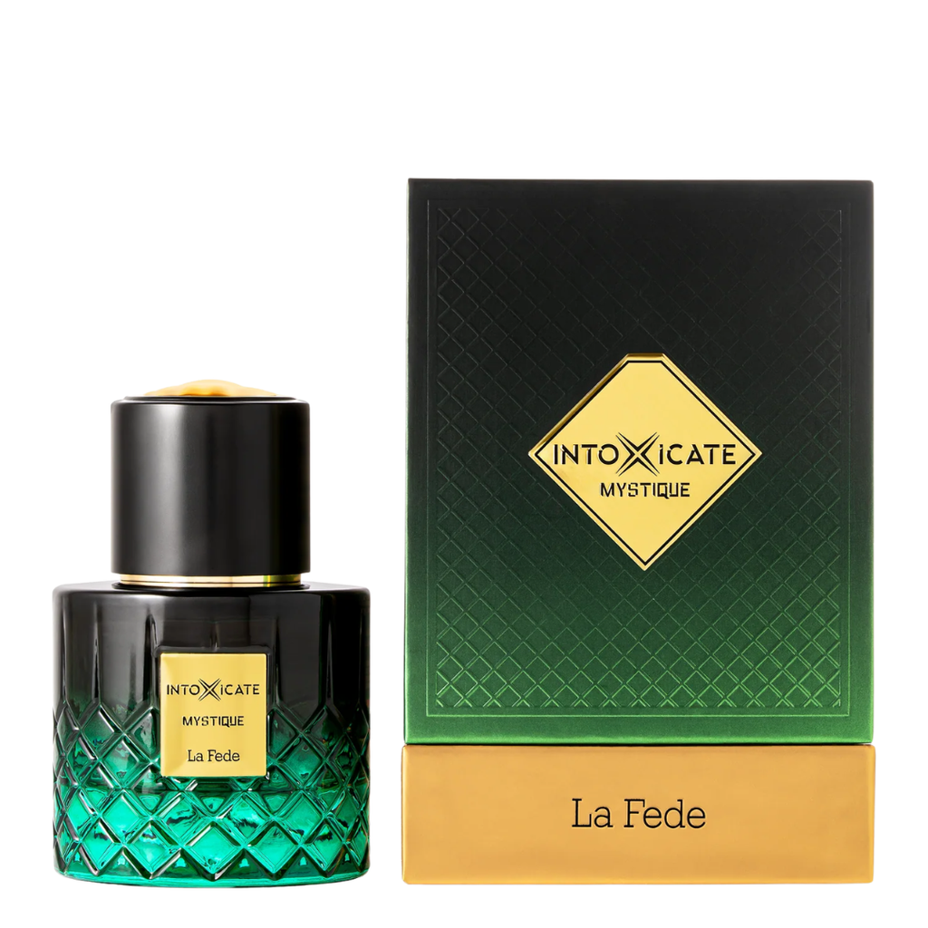 A bottle of INTOXICATE MYSTIQUE La Fede perfume next to its packaging box. The bottle is a dark green to black gradient with a textured diamond pattern and a gold cap.