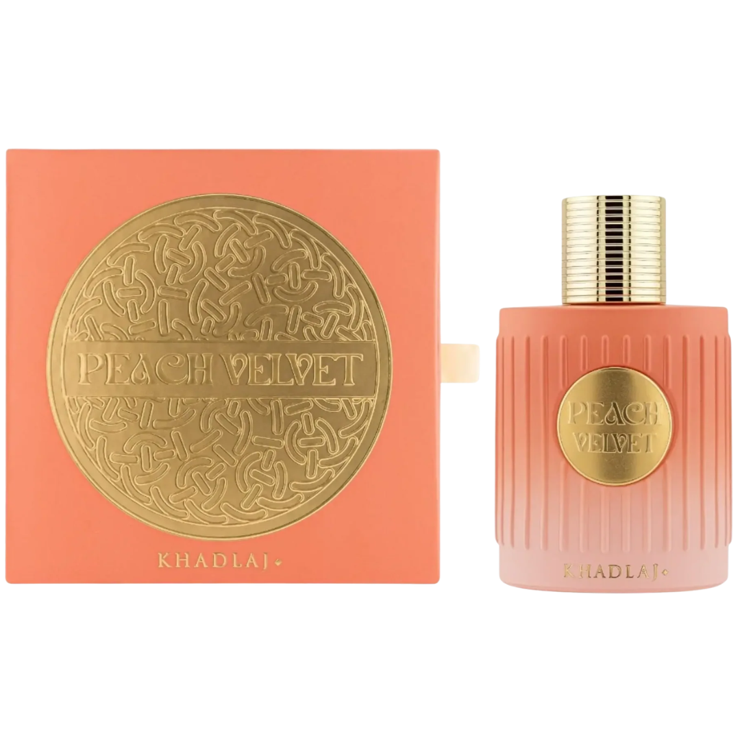 Khadlaj Peach Velvet perfume bottle and its matching peach-colored box, both featuring a textured gold circular emblem with the brand name.