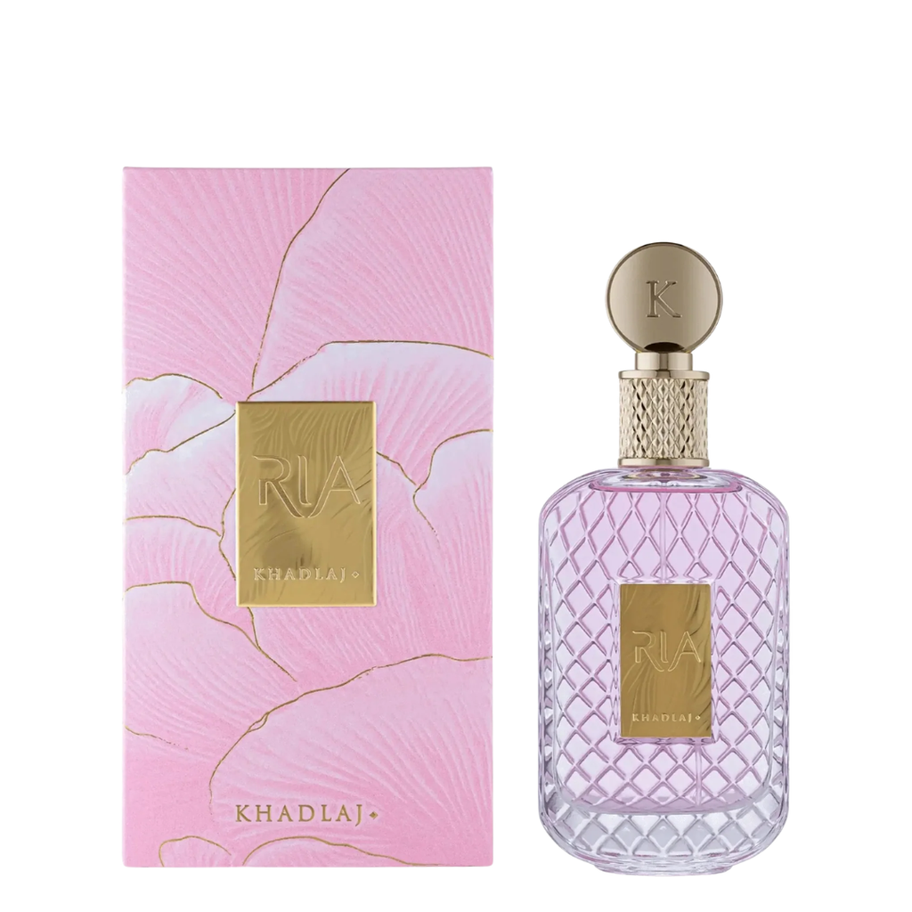 Khadlaj Ria perfume bottle and its pink floral box packaging, featuring a textured pink box with gold lines and a clear bottle with a diamond-patterned cap.