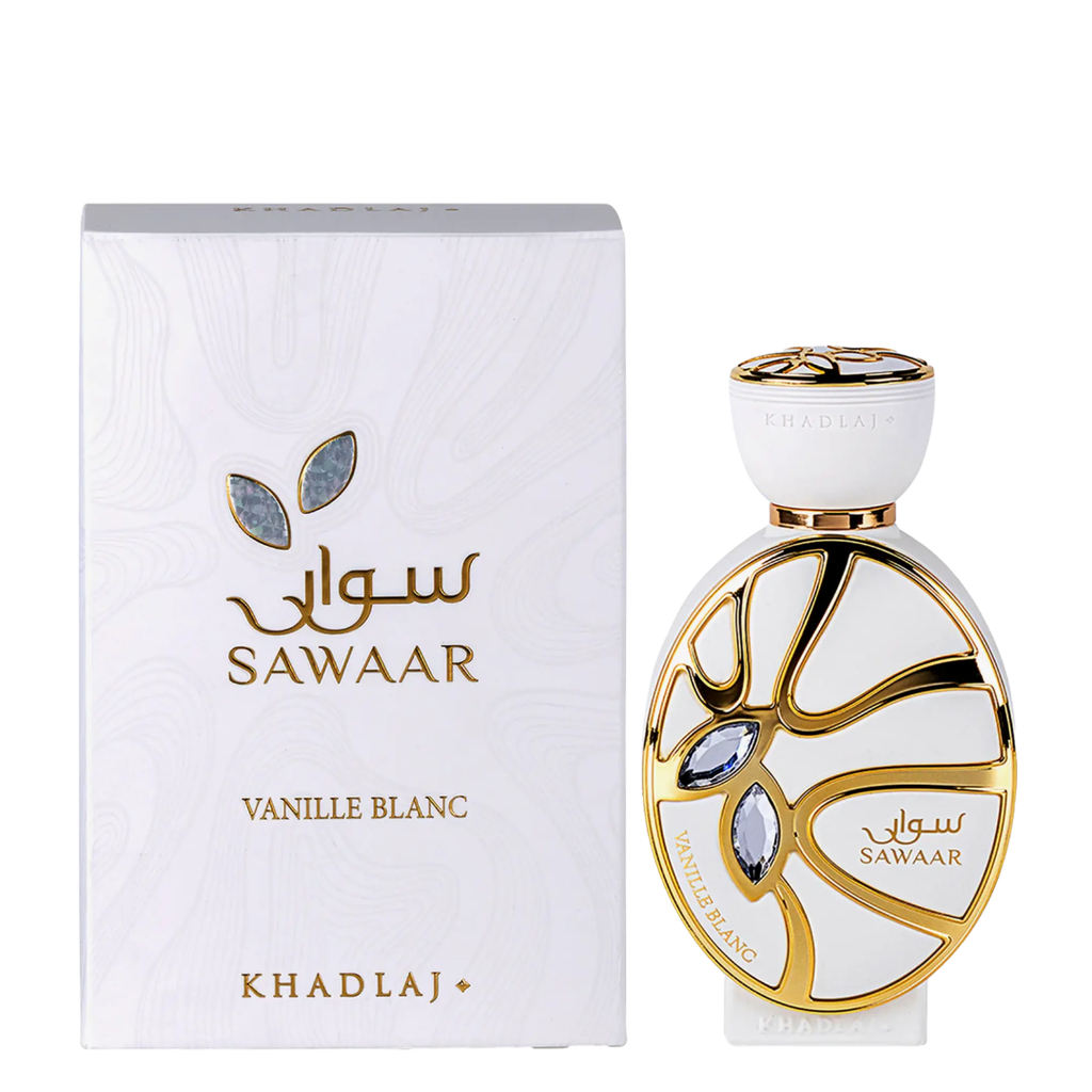 Sawaar Vanille Blanc perfume bottle and its white packaging box by KhadlaJ. The bottle is white with gold detailing and blue-gray leaf accents, standing next to its matching white box with gold lettering.