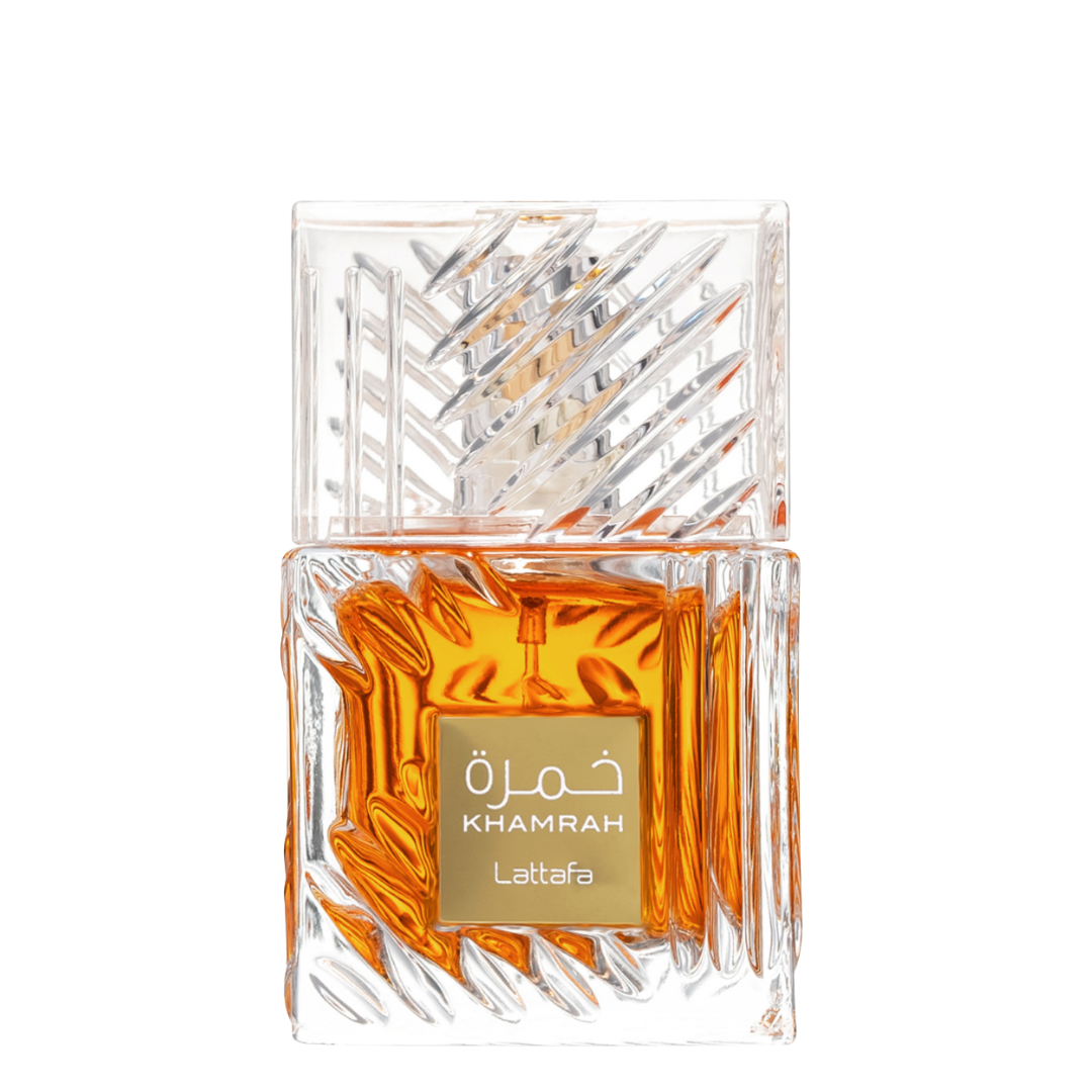 A luxurious crystal bottle of Khamrah unisex fragrance by Lattafa, displaying the amber-colored perfume liquid.  Close-Up of Lattafa Khamrah Perfume Bottle – Detailed view of the premium crystal-cut glass bottle with rich amber liquid and gold label, representing luxury oriental gourmand scents.