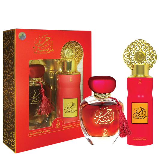 Red perfume bottles with gold caps and decorative packaging on a white background. Lamsat Harir Giftset by Arabiyat Womens Perfume