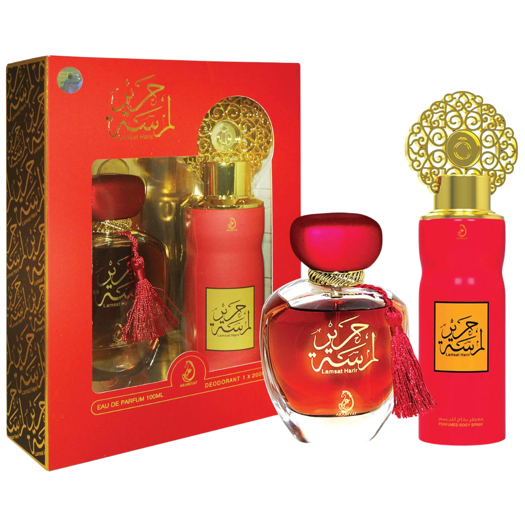 Red perfume bottles with gold caps and decorative packaging on a white background. Lamsat Harir Giftset by Arabiyat Womens Perfume