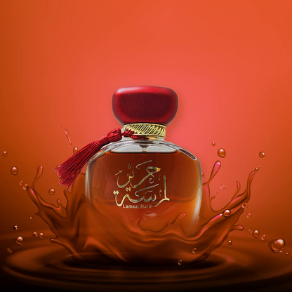 Perfume bottle with Arabic text on a red background. Lamsat Harir by Arabiyat Womens Perfume
