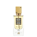 Close-up of Lattafa Ana Abiyedh Leather Eau de Parfum bottle – Elegant transparent glass perfume bottle with golden cap and intricate Arabic calligraphy label, filled with amber-colored fragrance liquid. 