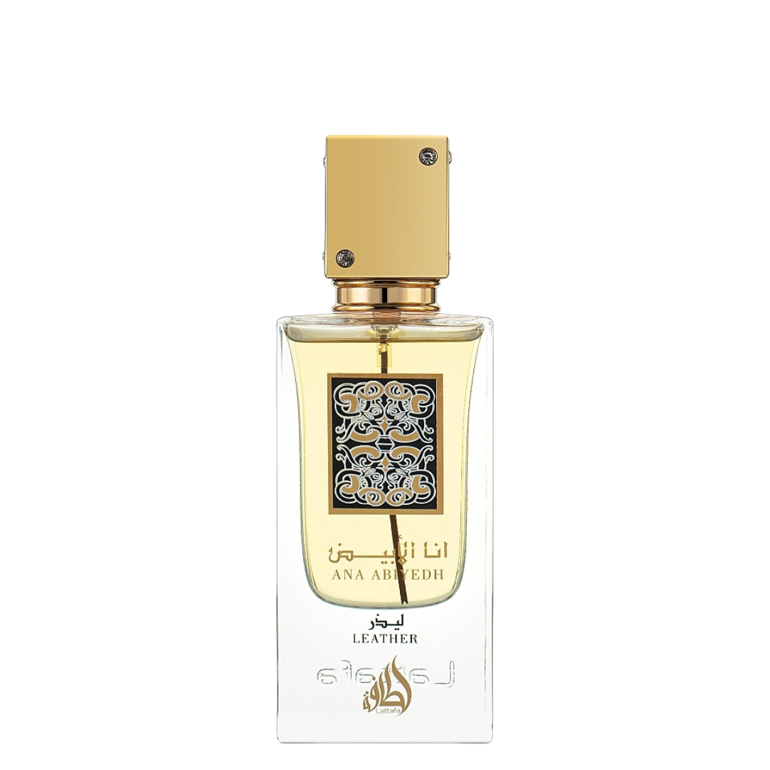 Close-up of Lattafa Ana Abiyedh Leather Eau de Parfum bottle – Elegant transparent glass perfume bottle with golden cap and intricate Arabic calligraphy label, filled with amber-colored fragrance liquid. 