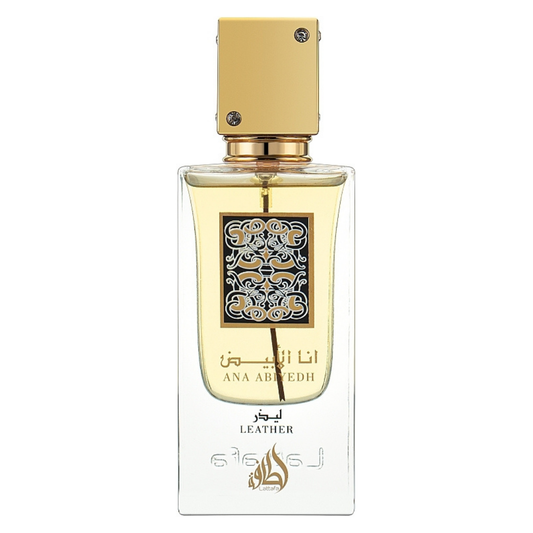 Close-up of Lattafa Ana Abiyedh Leather Eau de Parfum bottle – Elegant transparent glass perfume bottle with golden cap and intricate Arabic calligraphy label, filled with amber-colored fragrance liquid. Clone / dupe of / inspired by Memo Paris - African Leather perfume.