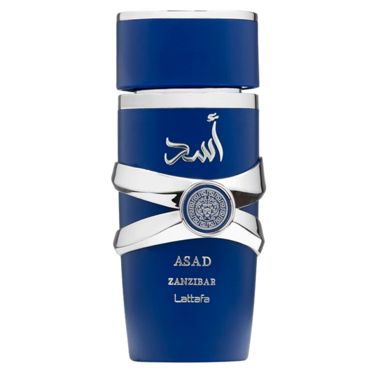 A blue perfume bottle with silver accents and a label with the brand name 'Asad Zanzibar' on it. Lattafa Asad Zanzibar Eau de Parfum bottle in royal blue with silver accents and Arabic calligraphy. Clone / dupe of / inspired by Jean Paul Gaultier - Le Beau perfume.