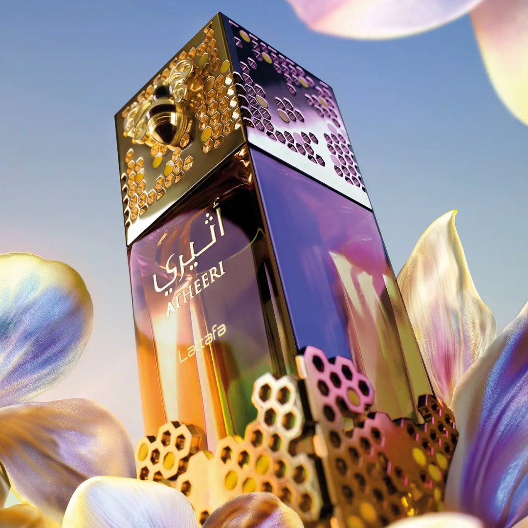 Luxurious perfume bottle with intricate design and 'Atheeri' branding against a floral background. Lattafa Atheeri Womens Perfume.