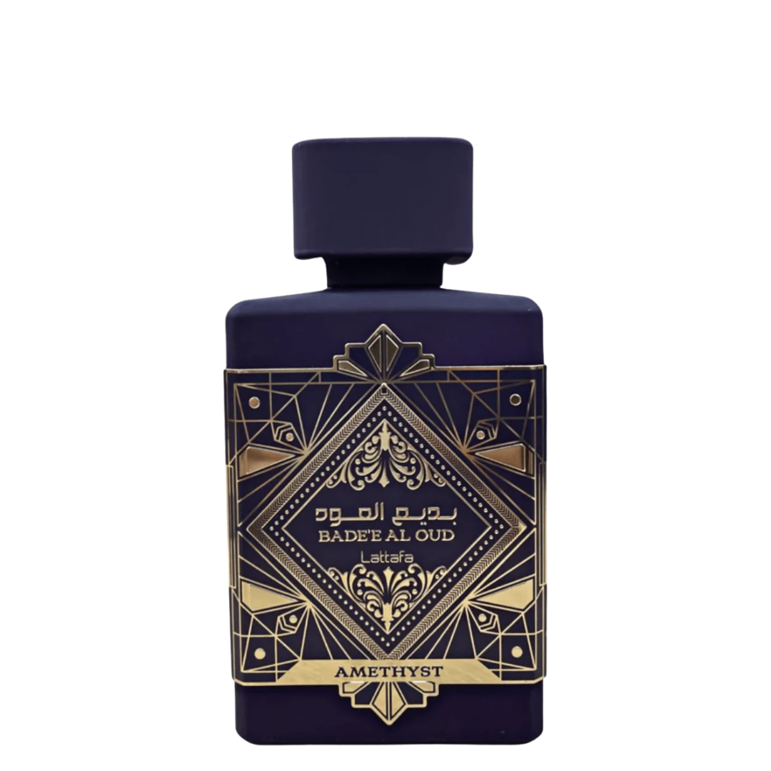 A perfume bottle of Badee Al Oud Amethyst with a dark purple to black gradient and gold geometric patterns. The label displays the product name and it is identified as an EDP by Lattafa.