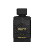 A rectangular black perfume bottle with a matching black cap, featuring gold Arabic and English lettering that reads 'BADEE AL OUD' and 'BLACK EXPOSED' on a clean white background.