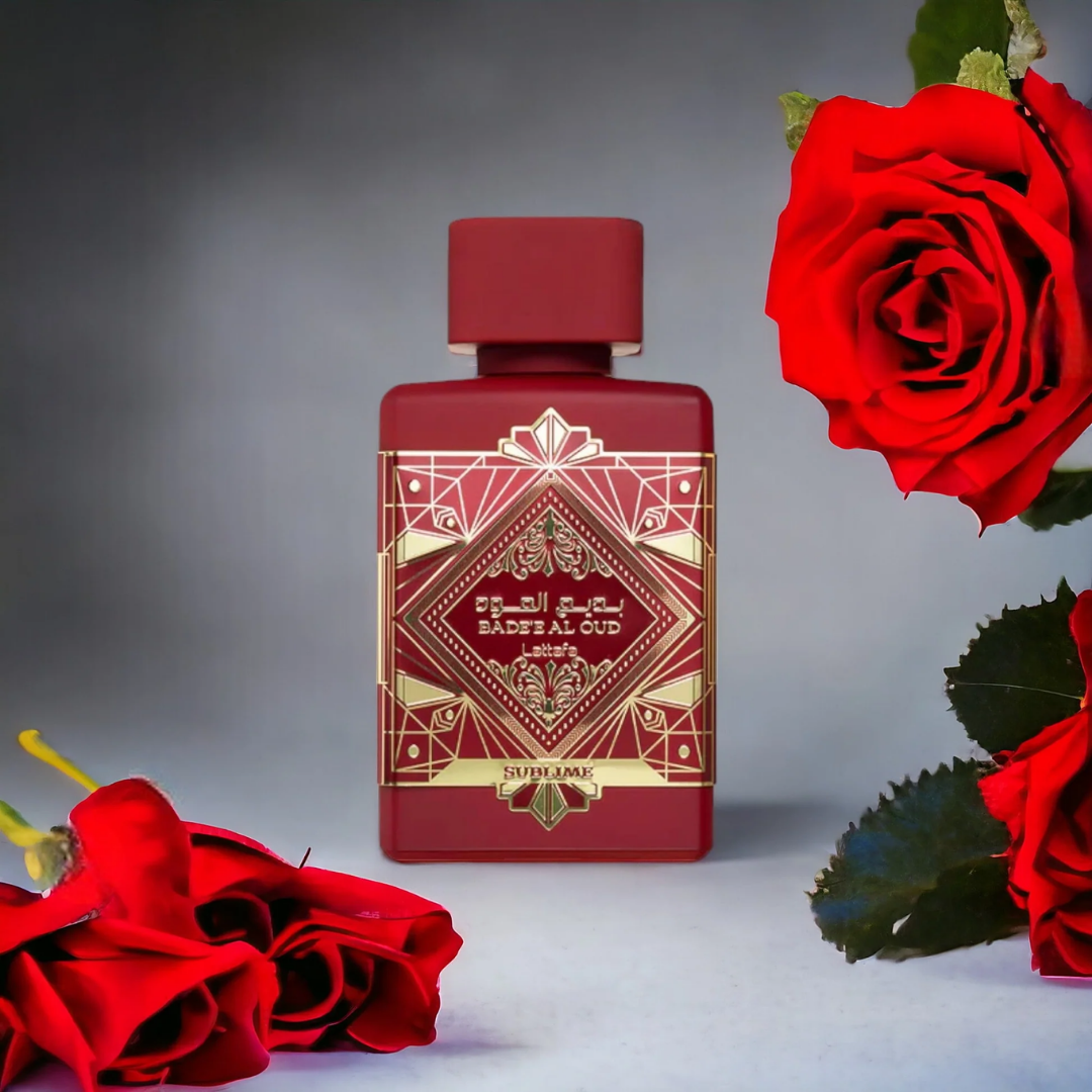 Red perfume bottle with gold detailing surrounded by red roses on a neutral background. Lattafa Badee Al Oud Sublime Unisex Perfume