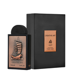 A bottle of Lattafa Creative Art Eau de Parfum next to its black presentation box, featuring a detailed bronze and copper-colored ship illustration on the bottle label.