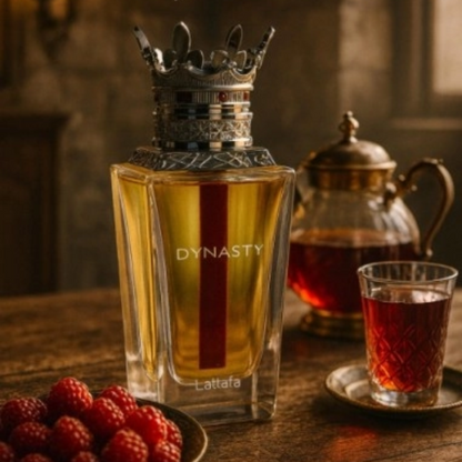 Perfume bottle labeled 'Dynasty' with a teapot and cup on a wooden table. Lattafa Dynasty Unisex Perfume.