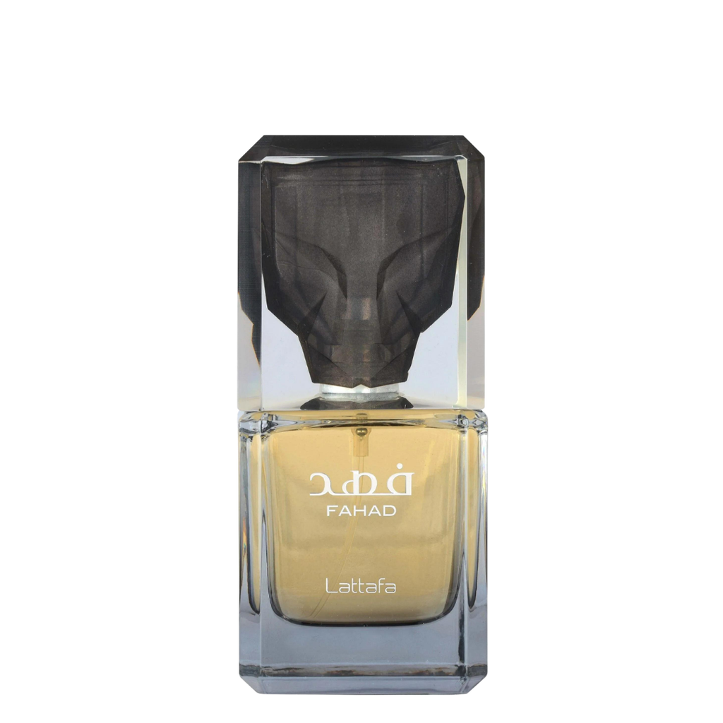 A faceted glass perfume bottle with a dark gray cap and golden-yellow liquid inside, labeled 'FAHAD' and 'Lattafa', on a plain white background.