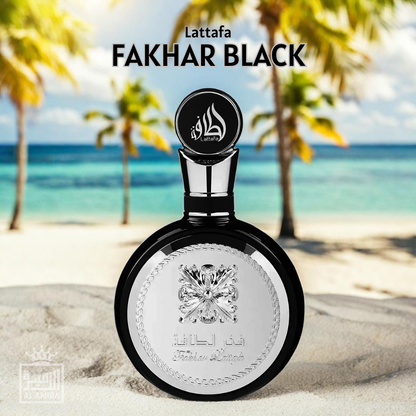 Lattafa Fakhar Black perfume bottle on a beach with palm trees and blue sky. Clone / dupe of / inspired by Yves Saint Laurent - Y perfume.