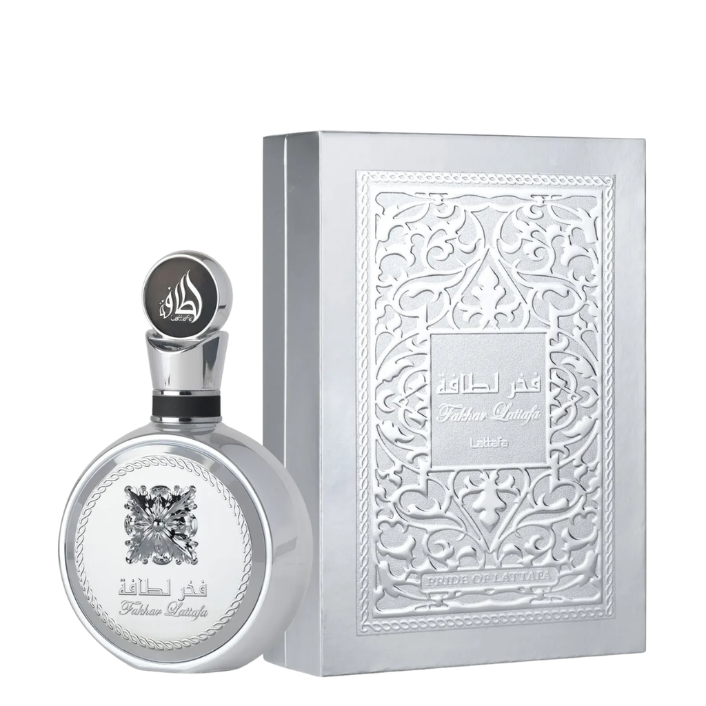 A silver perfume bottle with a matching ornate silver box, both featuring Arabic and English text and decorative embossed patterns, photographed on a plain white background.
