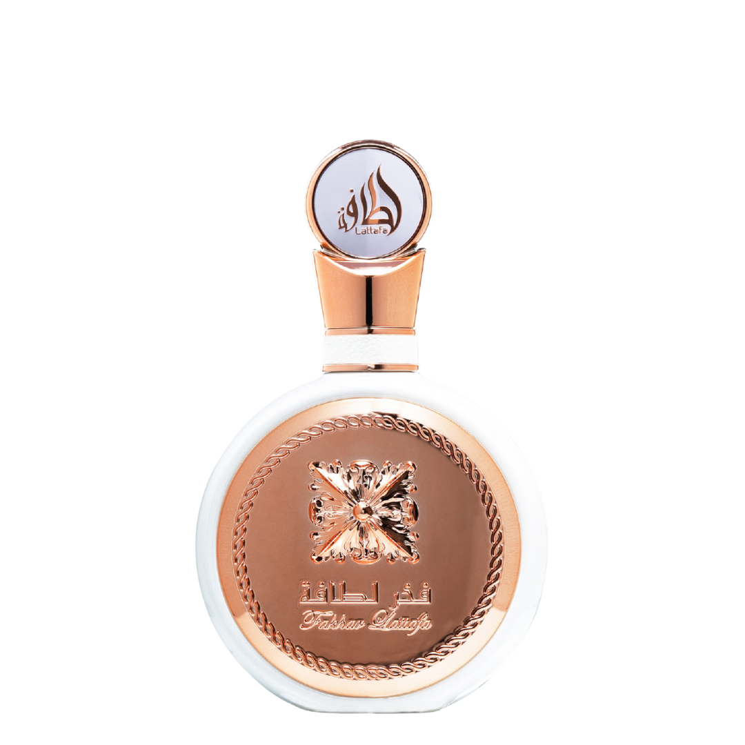 A bottle of Fakhar Rose perfume from Lattafa, with a rose gold cap and label featuring an intricate design. Lattafa Fakhar perfume bottle featuring a round white body with ornate rose-gold emblem and Arabic calligraphy, exuding elegance and sophistication.