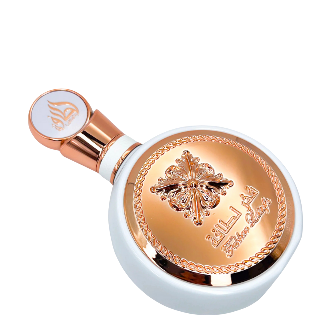 Lattafa Fakhar Eau de Parfum bottle in a horizontal position, highlighting the detailed rose-gold medallion design and premium craftsmanship. 