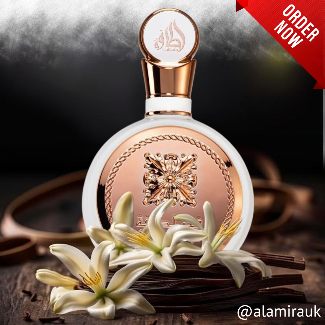 Perfume bottle with flowers on a dark background, featuring a 'Order Now' banner. Lattafa Fakhar perfume bottle featuring a round white body with ornate rose-gold emblem and Arabic calligraphy, exuding elegance and sophistication. 