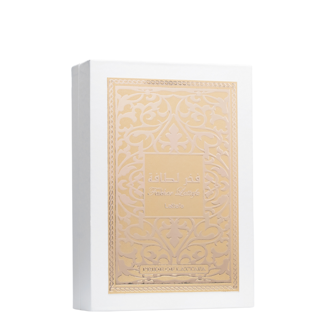 Lattafa Fakhar perfume box in elegant white with embossed gold Arabic pattern and calligraphy, symbolizing luxury Middle Eastern perfumery. 