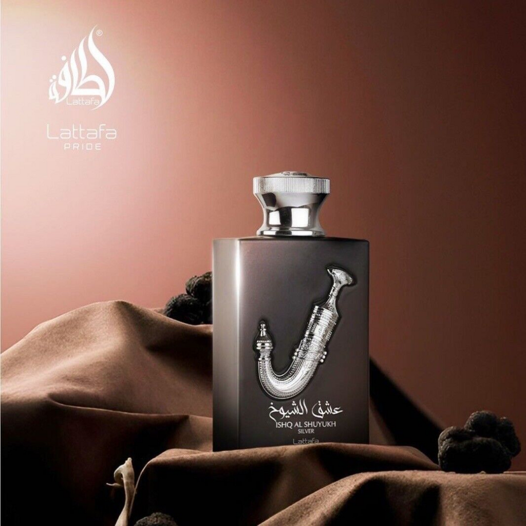 Perfume bottle with silver cap on a brown fabric background, featuring Lattafa brand. Lattafa Ishq Al Shuyukh Silver Unisex Perfume