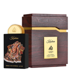 Kashan Lattafa Arabian perfume bottle with a gold cap next to its dark brown wooden box packaging with gold accents.