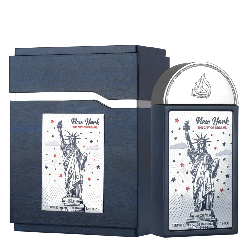 New York The City of Dreams Eau de Parfum bottle and its matching dark blue presentation box, both featuring a silver and white illustration of the Statue of Liberty.