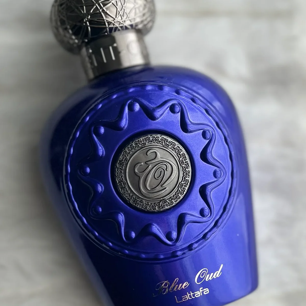 Blue perfume bottle with intricate design on a white background. Lattafa Opulent Blue Oud Unisex Perfume
