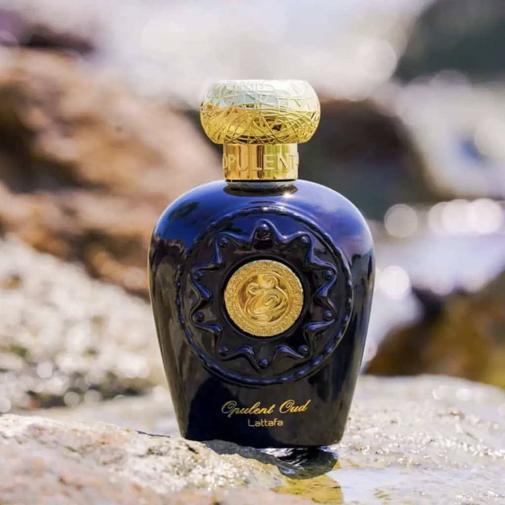 Perfume bottle with gold cap on a textured surface. Lattafa Opulent Oud Unisex Perfume