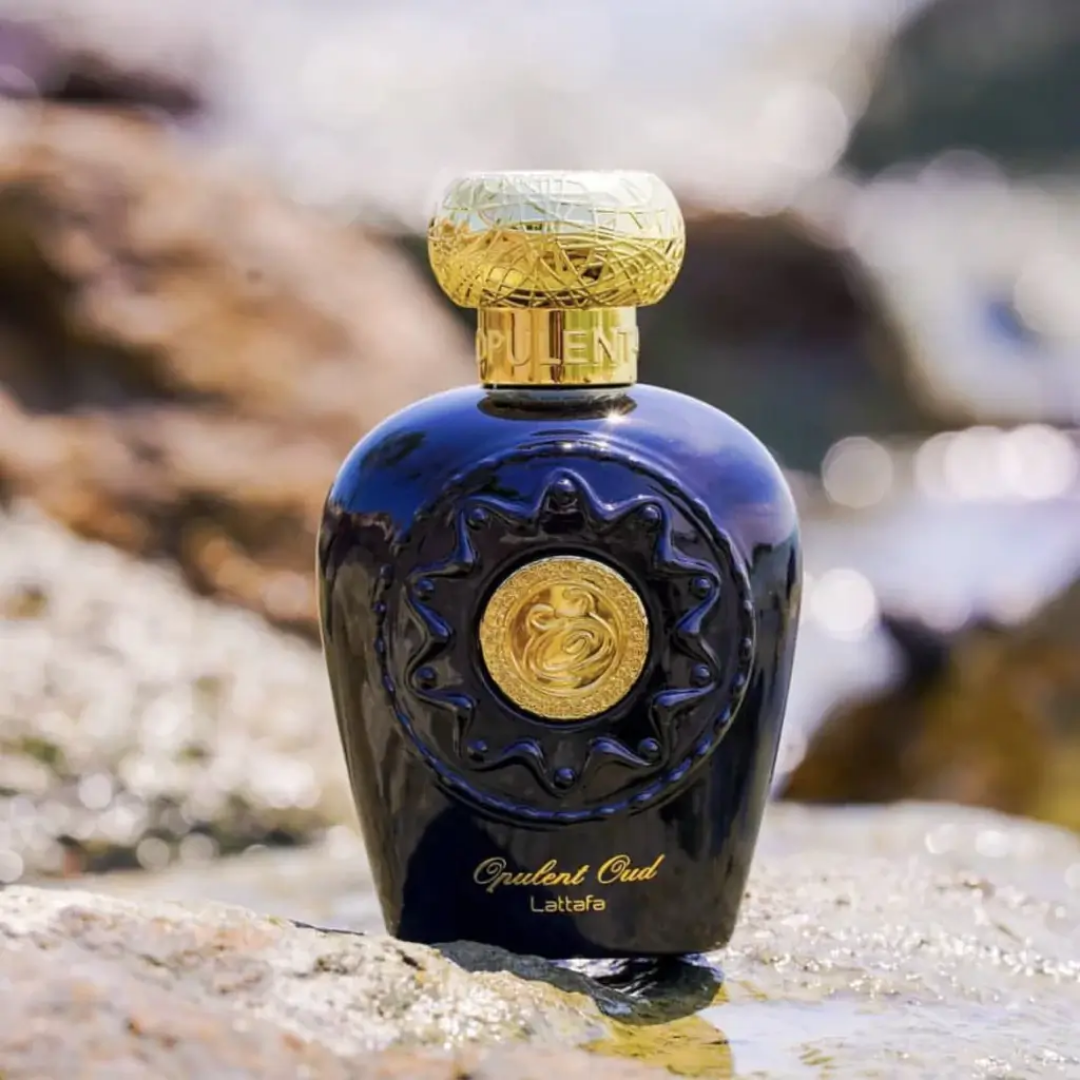 Perfume bottle with gold cap on a textured surface. Lattafa Opulent Oud Unisex Perfume