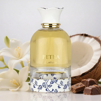 Petra Lattafa perfume bottle with coconut, flowers, and chocolate on a light background