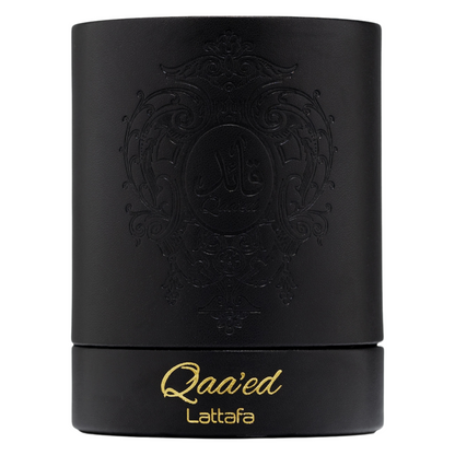 Elegant black cylindrical Lattafa Qaa’ed perfume box with gold embossed lettering and intricate Arabic design, representing high-end Arabian perfumery. Clone / dupe of / inspired by Dolce & Gabbana - Velvet Desert Oud perfume.