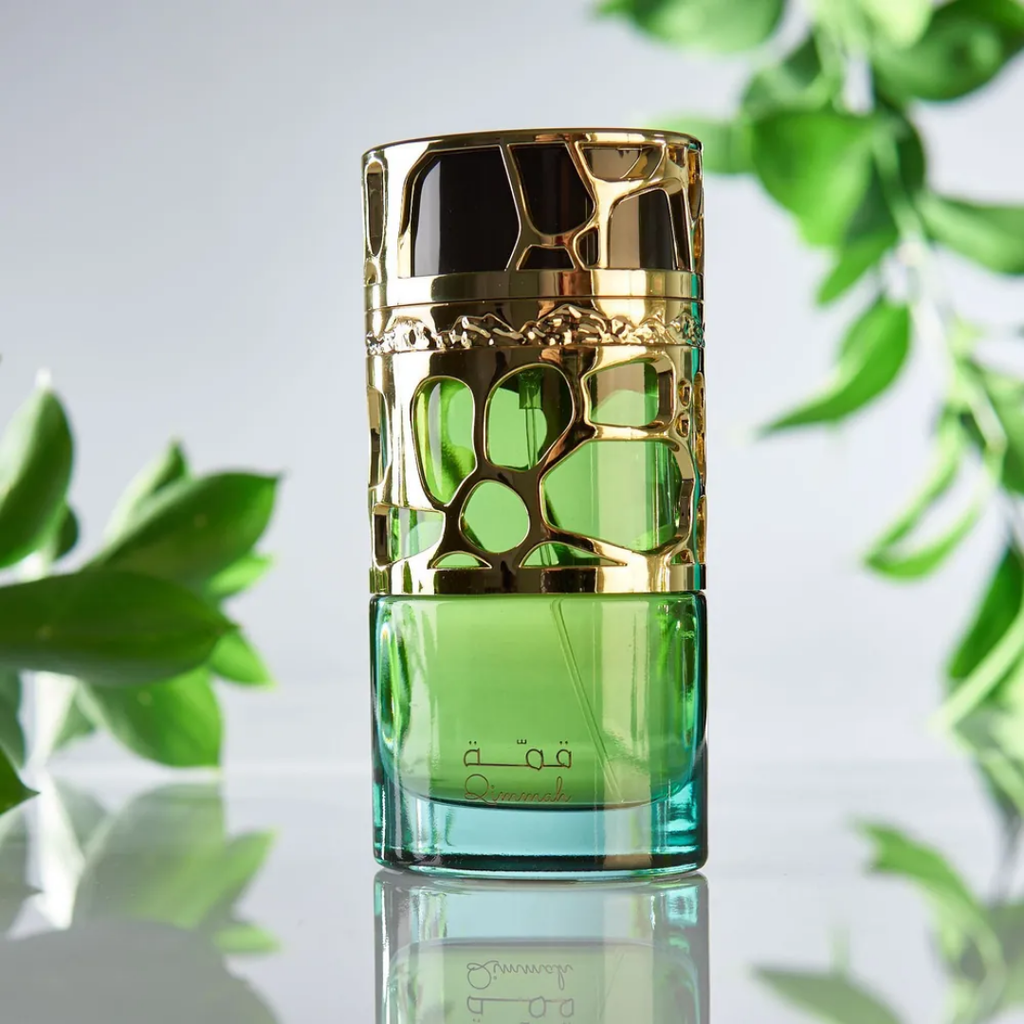 Green and gold cosmetic bottle with leafy background. Lattafa Qimmah for Women Perfume