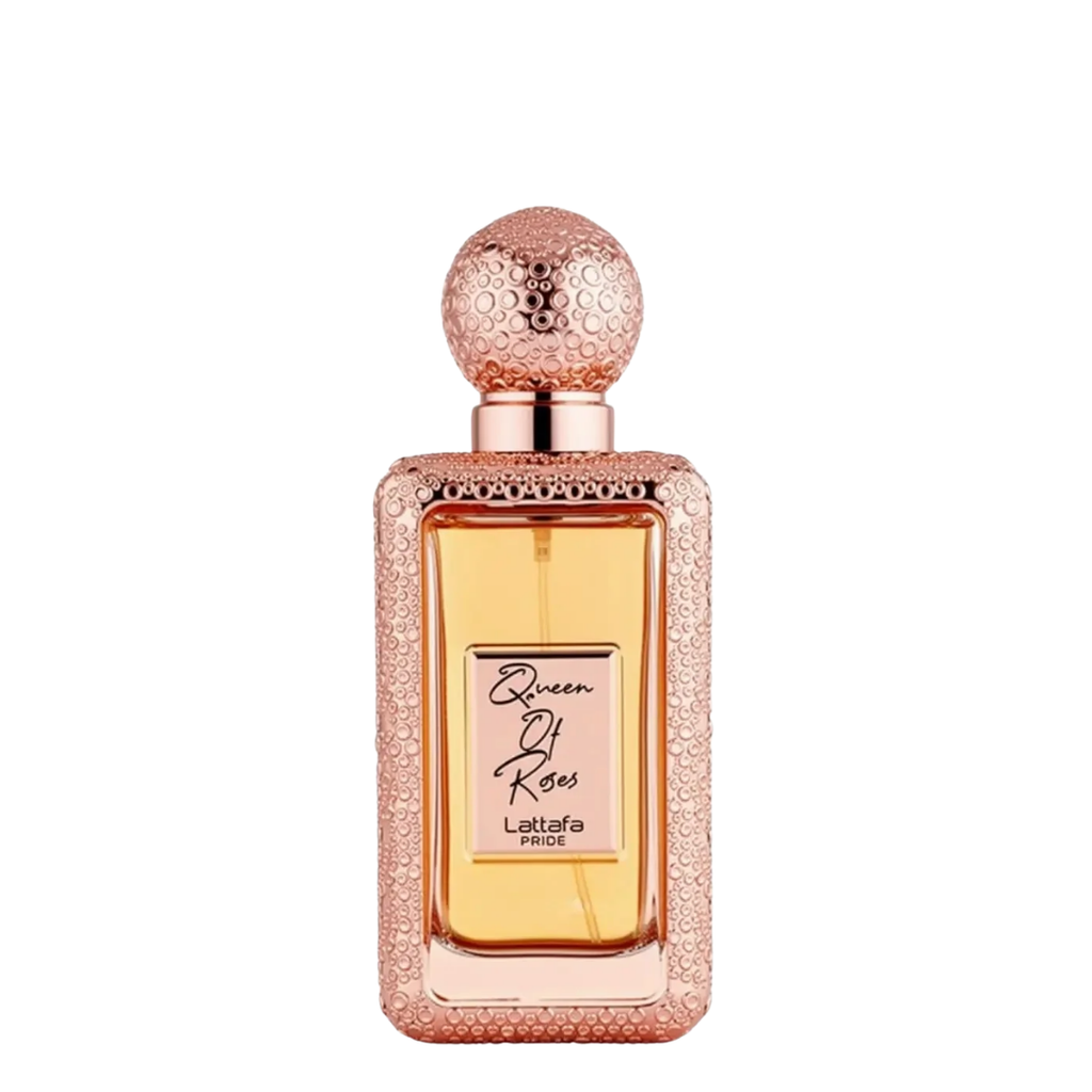 A rectangular bottle of Lattafa Queen of Roses perfume with a textured rose gold cap and a glittery rose gold frame, containing amber-colored liquid, set against a plain white background.