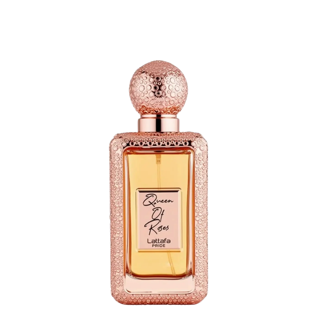 A rectangular bottle of Lattafa Queen of Roses perfume with a textured rose gold cap and a glittery rose gold frame, containing amber-colored liquid, set against a plain white background.