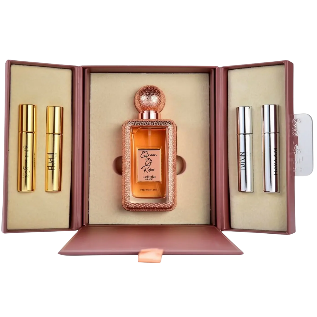 A perfume gift set displayed in an open mauve-brown presentation box on a white background. The set includes a central rectangular perfume bottle with amber liquid and a rose-gold cap, flanked by two gold tubes on the left and two silver tubes on the right.. Lattafa: Queen of Roses