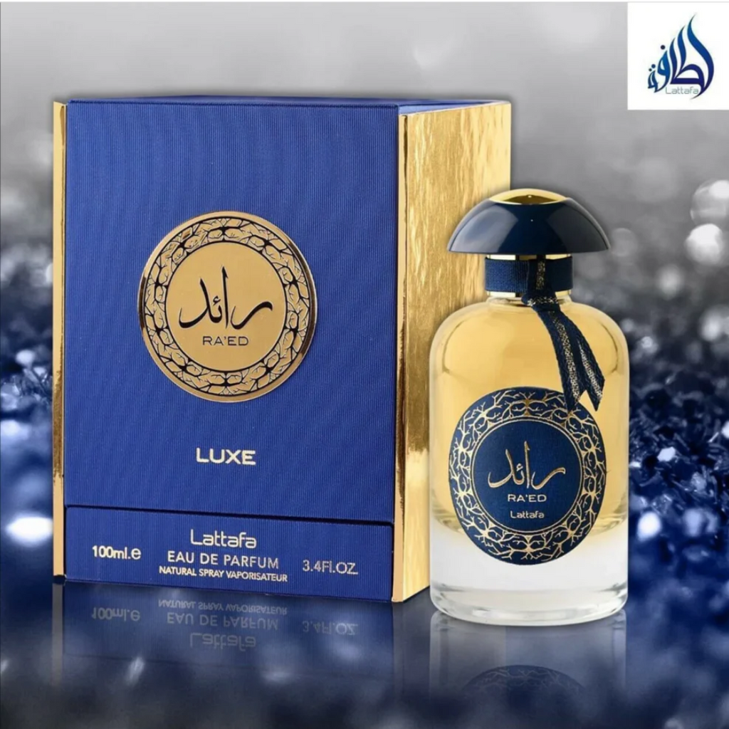 Lattaafa Ráéd perfume bottle and packaging on a reflective surface with blurred background. Lattafa Ra'ed Luxe Unisex Perfume