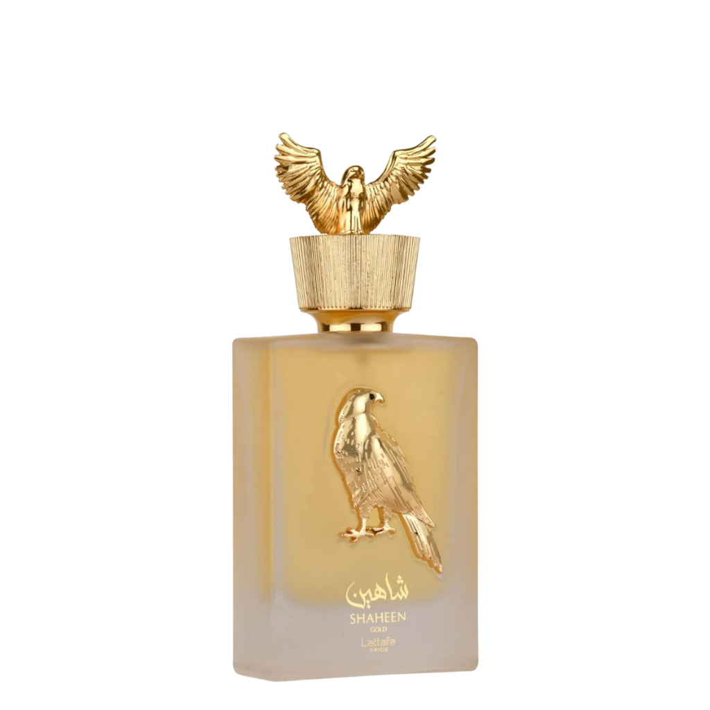 Lattafa Shaheen Gold perfume bottle with a gold falcon cap and a gold falcon emblem on a frosted beige glass bottle, set against a plain white background.