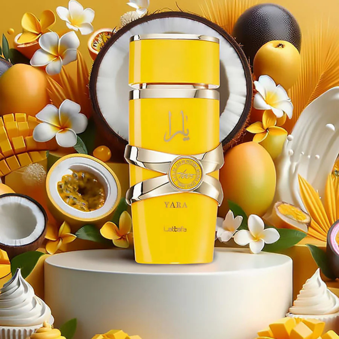 Lattafa Yara Tous perfume bottle surrounded by tropical fruits, coconut, and mango – exotic sweet summer scent for women. 