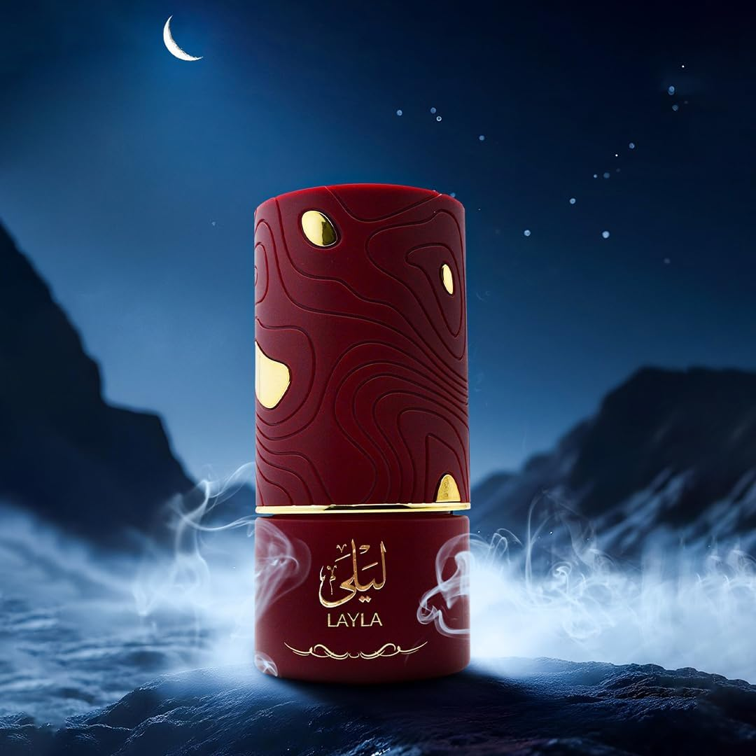 Red and gold perfume bottle labeled 'Layla' against a mystical mountain and moon background