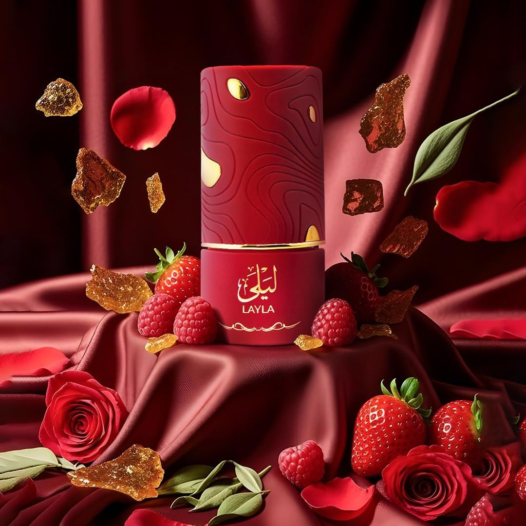 Red cylindrical product with 'LAYLA' branding on a red fabric background with berries and roses.