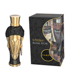 A bottle of Cleo Reine D'Or perfume next to its retail box. The bottle is shaped like a gold and black sculpted head with a gold cap, and the box features a black background with a stylized face illustration and gold lettering. Le Bonheur: Reine d'Or Cleo