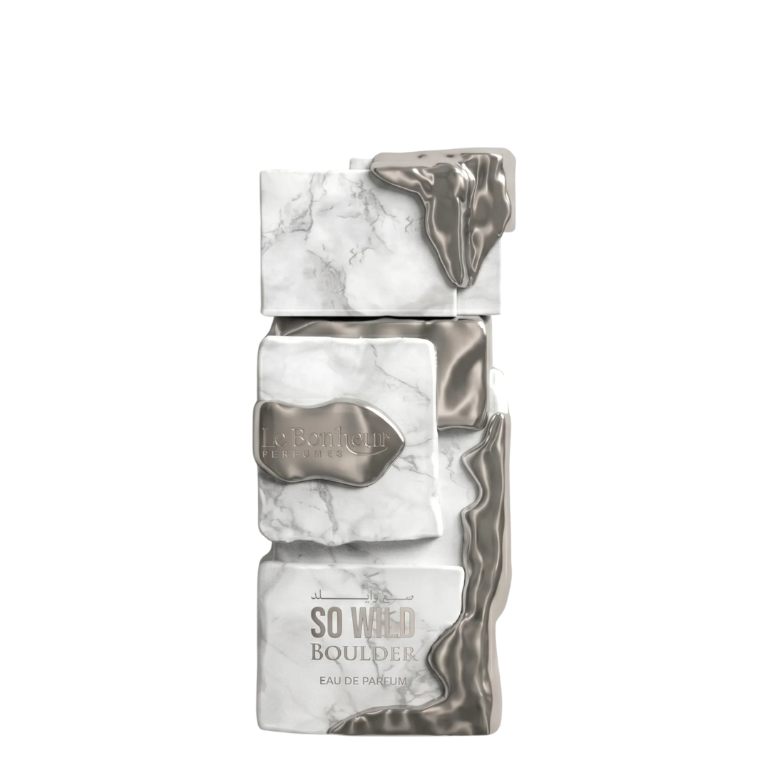 A rectangular perfume bottle with a stacked marble and metallic silver design, featuring the text 'So Wild Boulder' and 'Eau de Parfum'. Le Bonheur: So Wild Boulder.