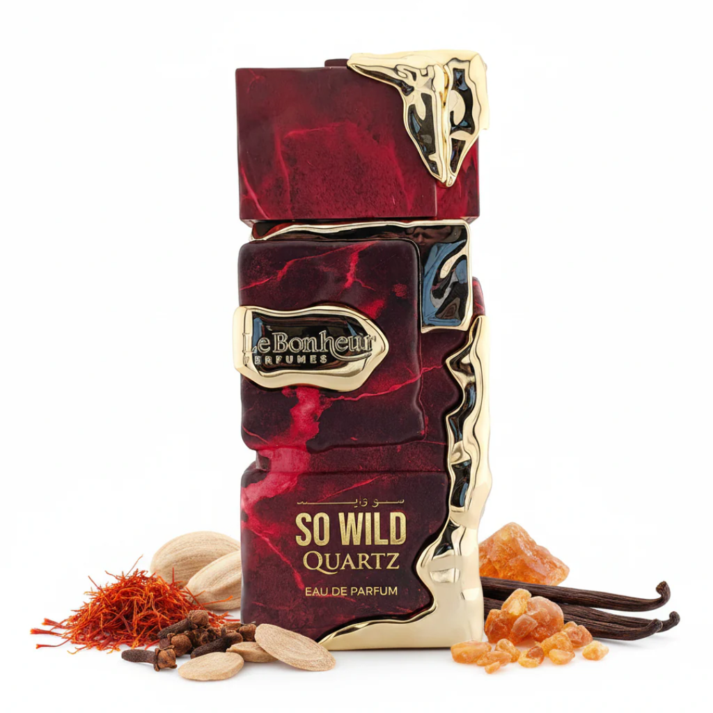 Red and gold perfume bottle with 'Le Bonheur' branding and 'So Wild Quartz' text, surrounded by spices on a white background.
